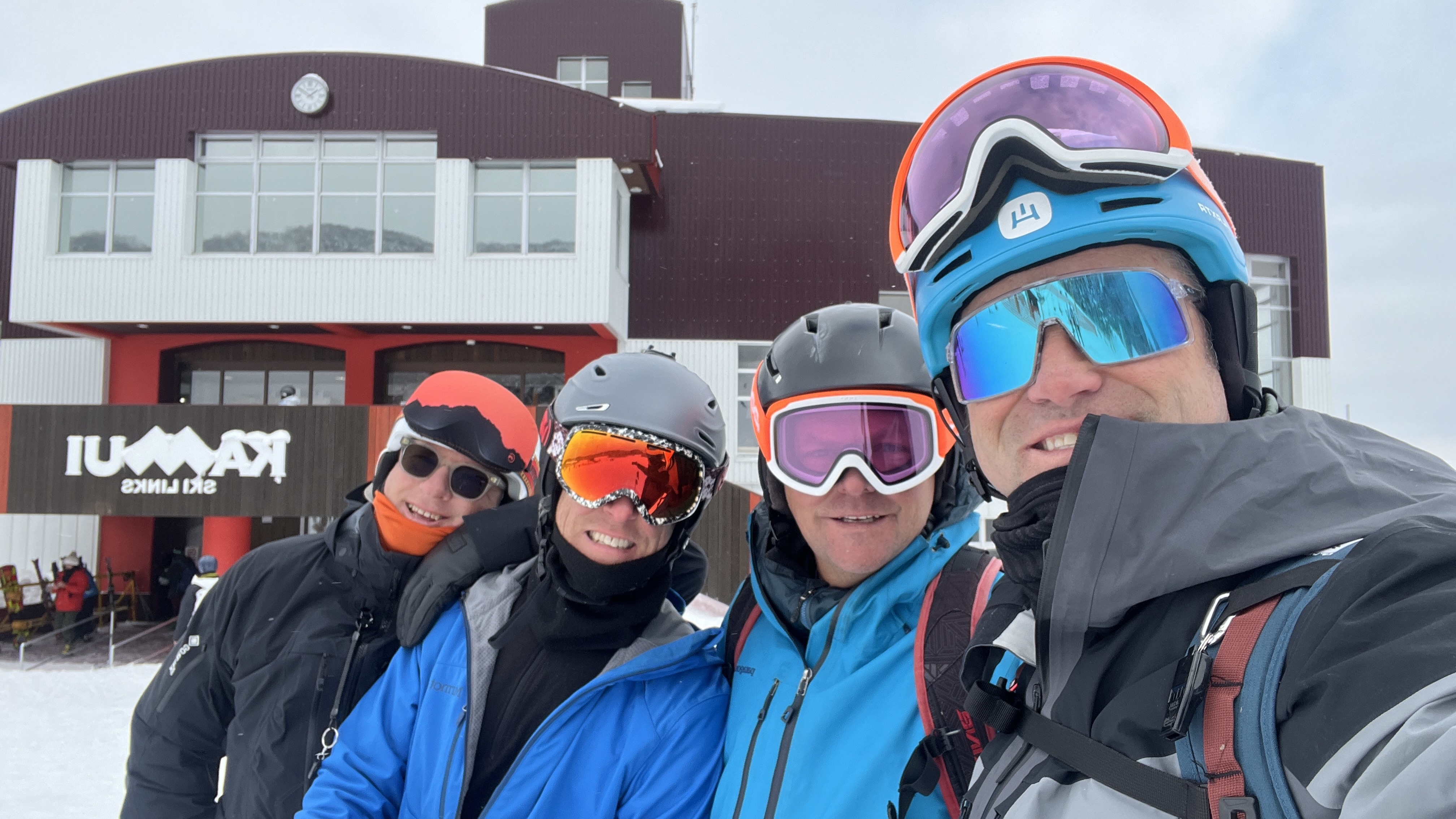 A group of skiers enjoying a snowy day together in Hokkaido